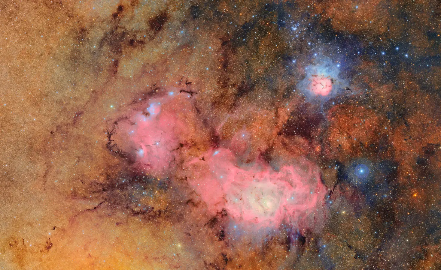 A colorful image of outer space with clouds of gas and dust.