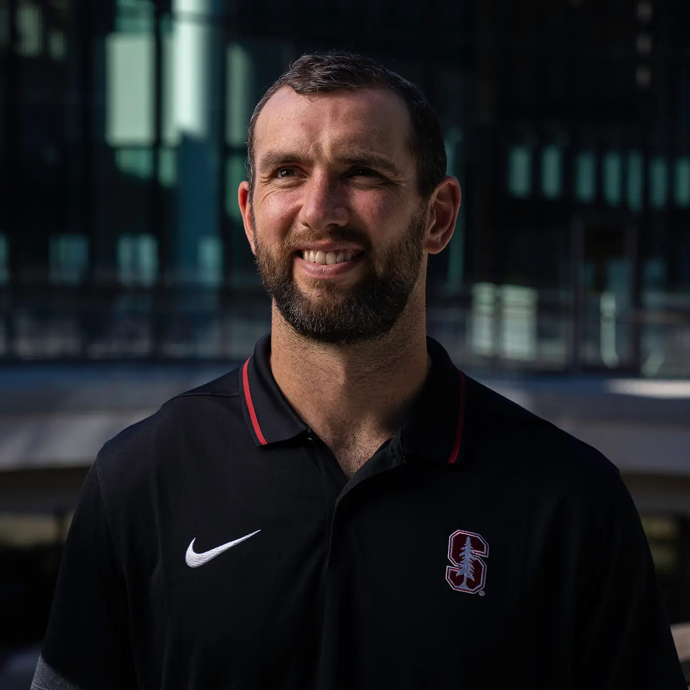 Andrew Luck smiles in a Stanford polo tshirt