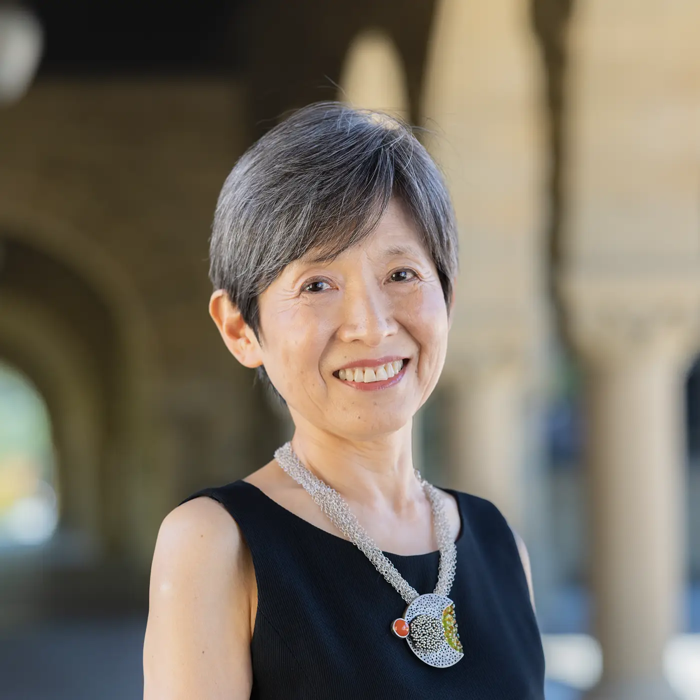 Michael McFaul sits at a desk chatting with student Andrii Torchylo