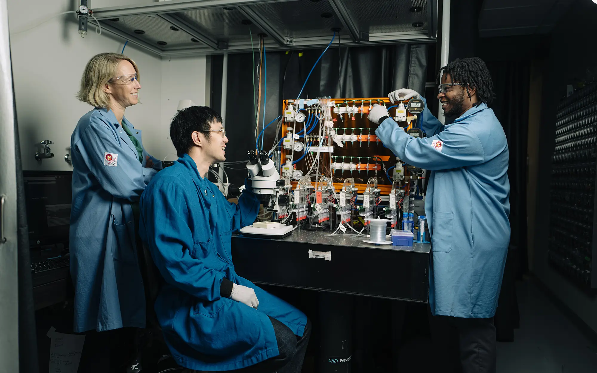 Polly in lab with researchers Alan and Eliel