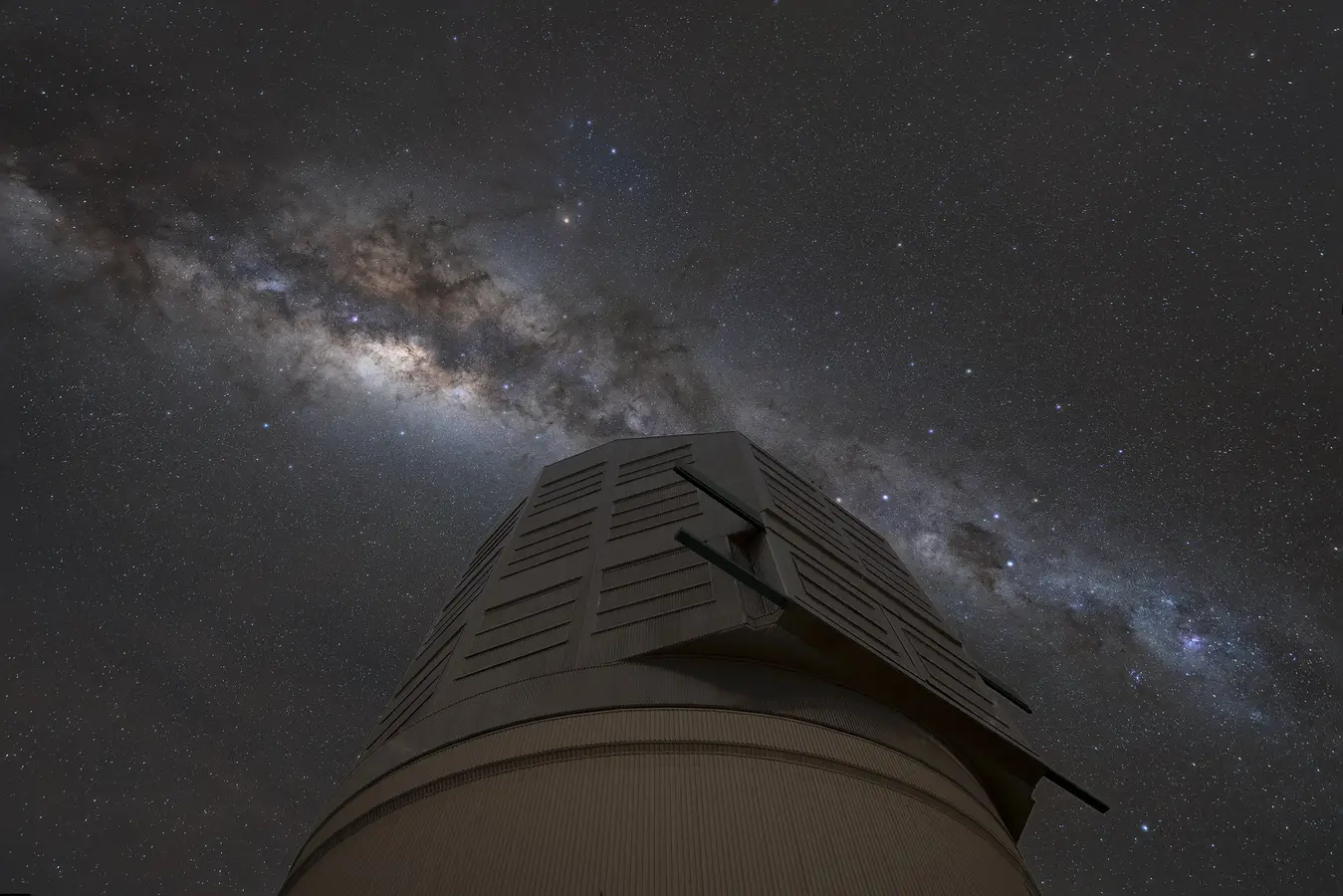 An outdoor image of the Rubin Observatory showing stars in the background