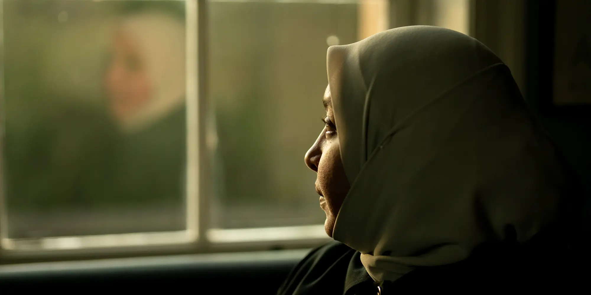 Rania looks out a window