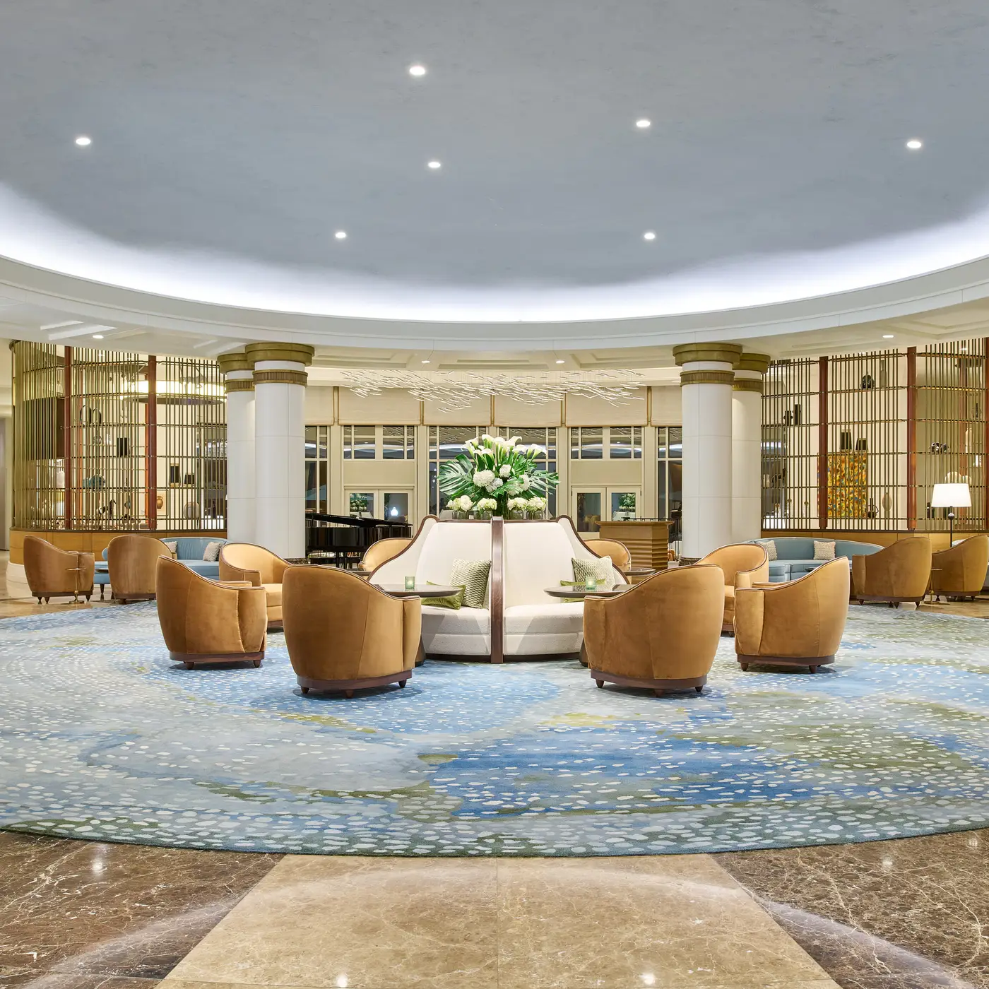 Pink lights and chandeliers in large white room