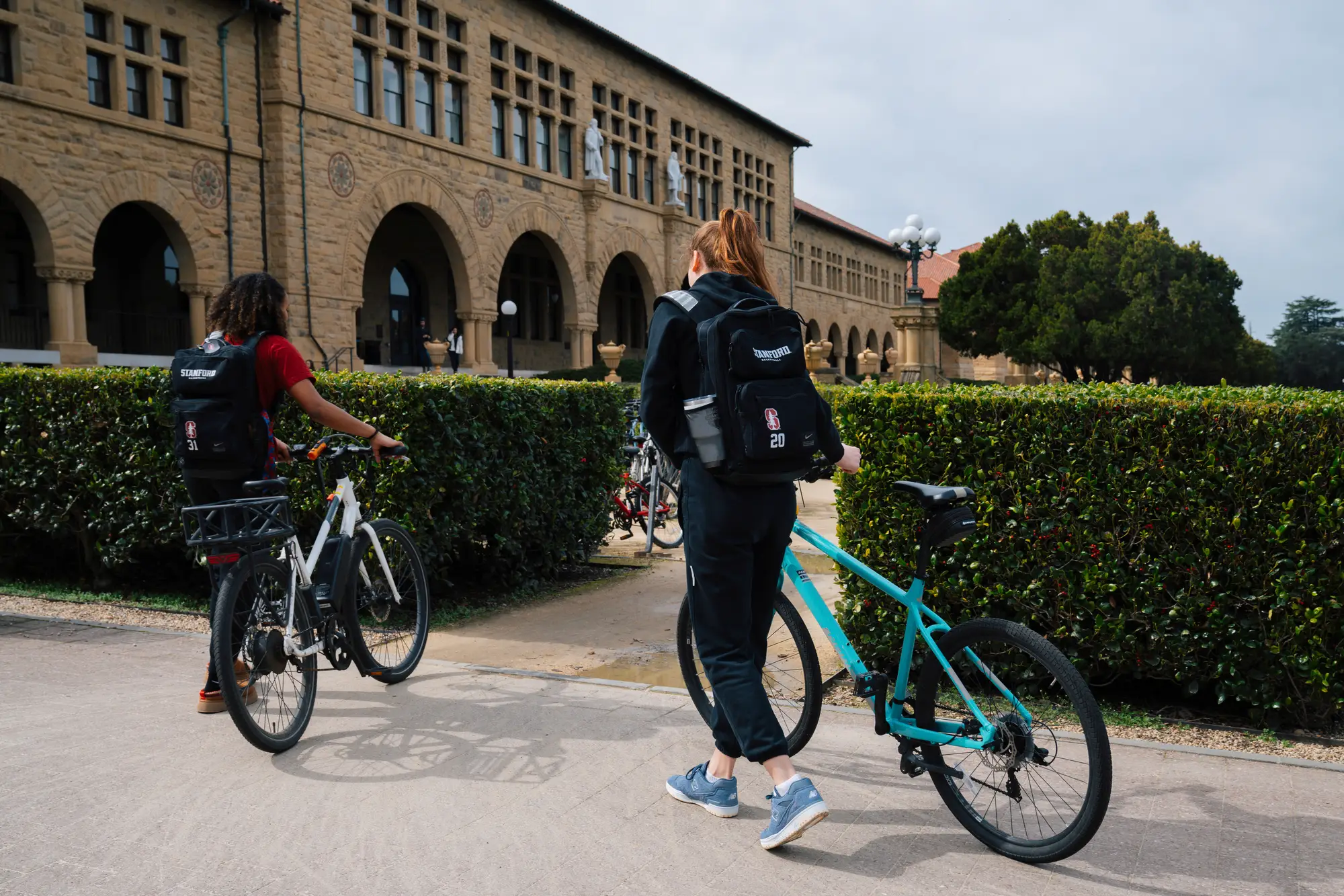 Two players bike across campus. 