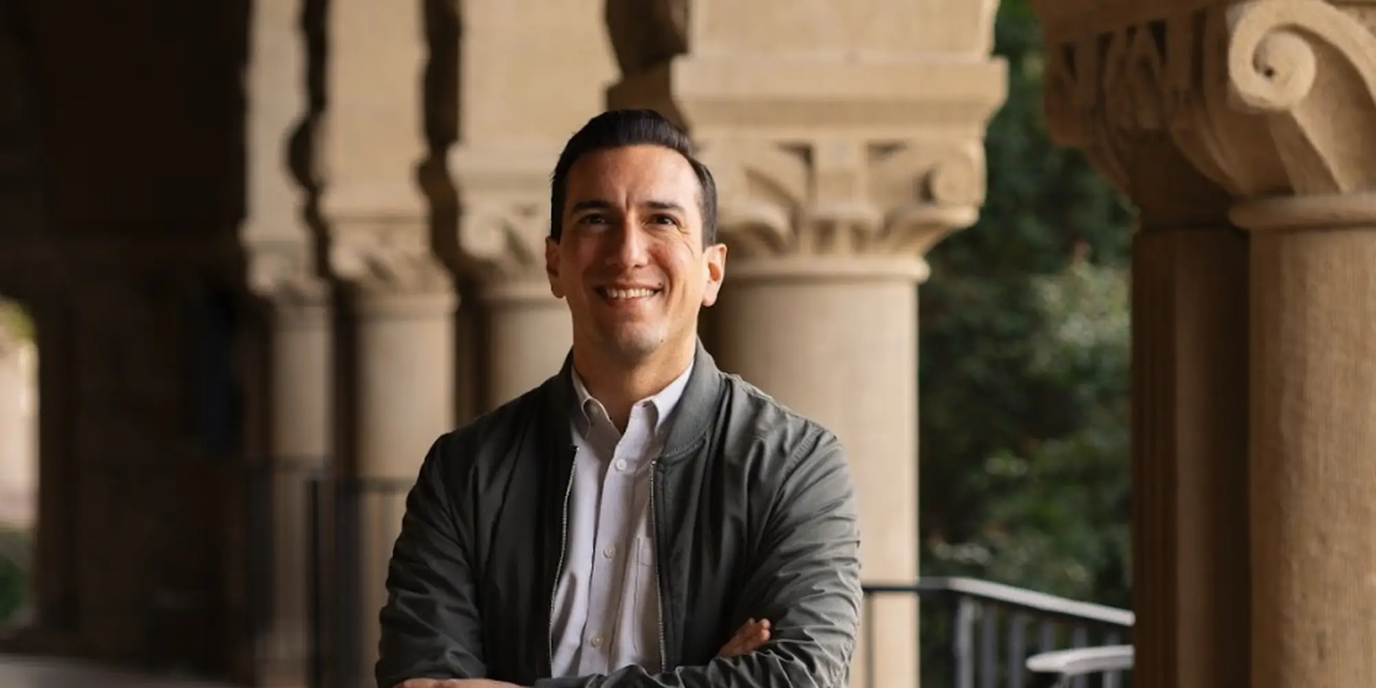 Jamil Zaki stands on campus