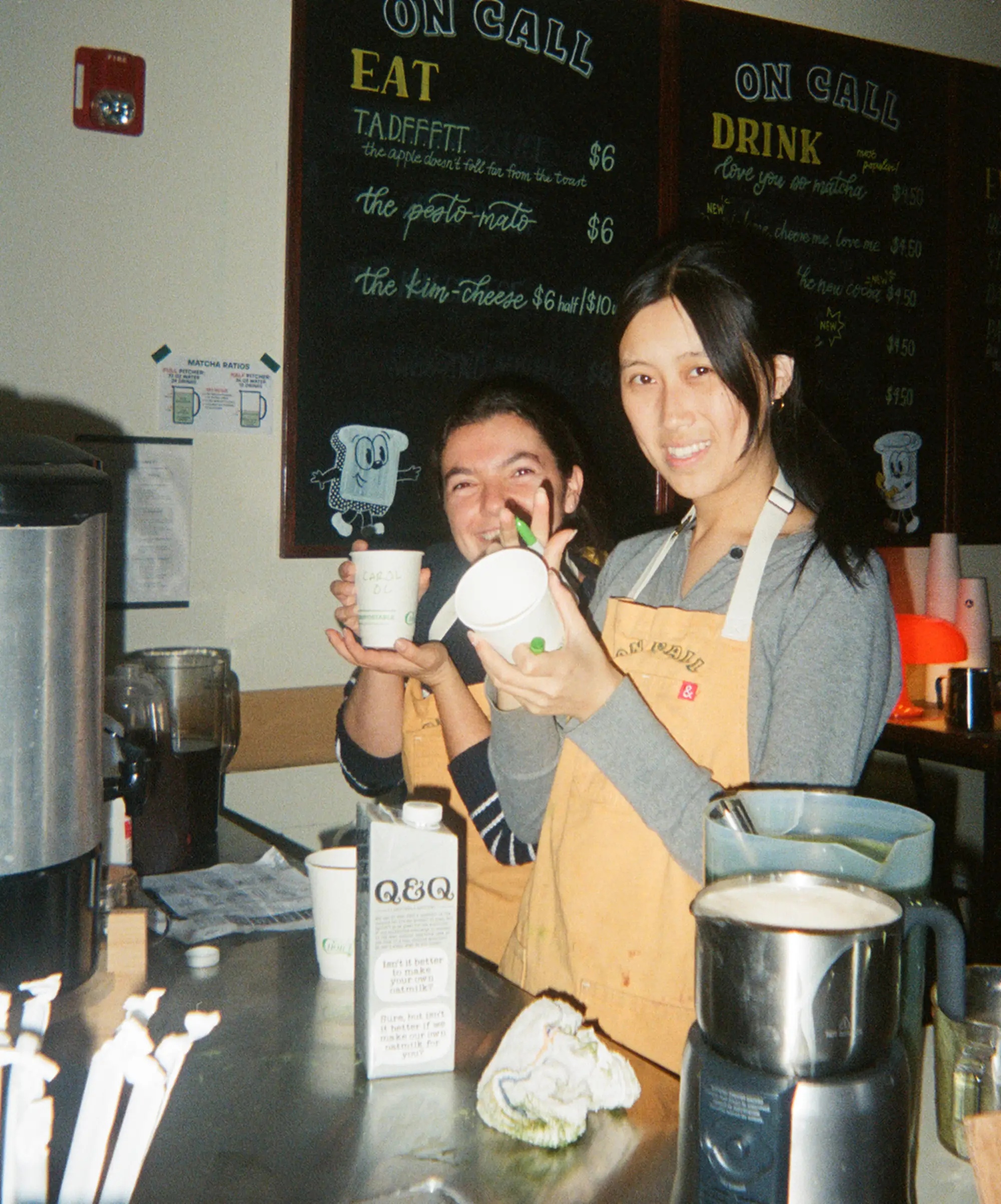 On Call Cafe barista writing on a coffee cup