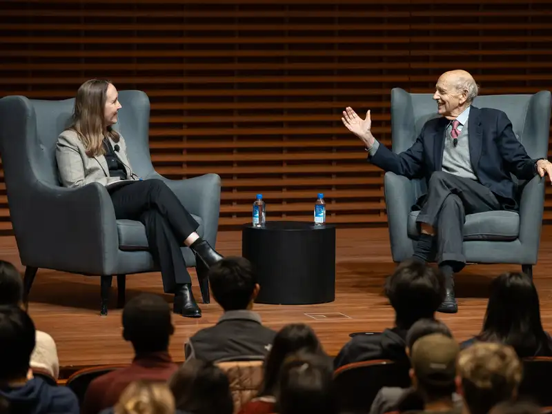 Justice Breyer and Jenny Martinez sitting on stage during an event at Stanford.
