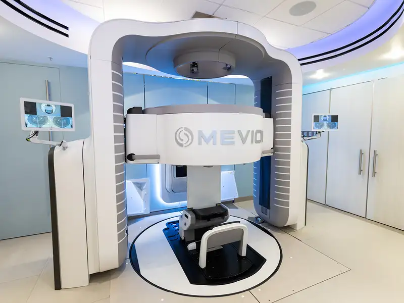 A modern medical imaging machine, designed for advanced diagnostic scans, featuring a central scanning area and sleek, futuristic design.