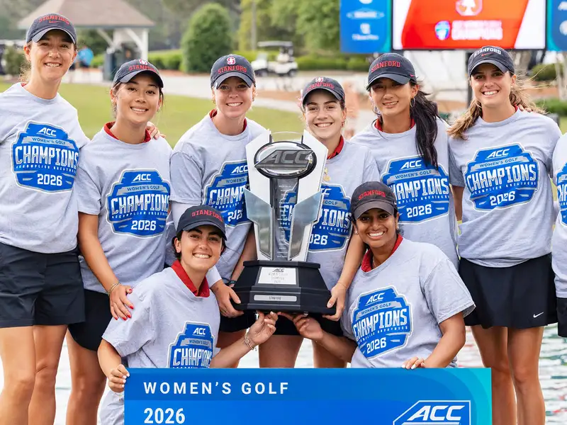 Stanford women's golf team celebrates their 2026 ACC championship victory while holding a large trophy.