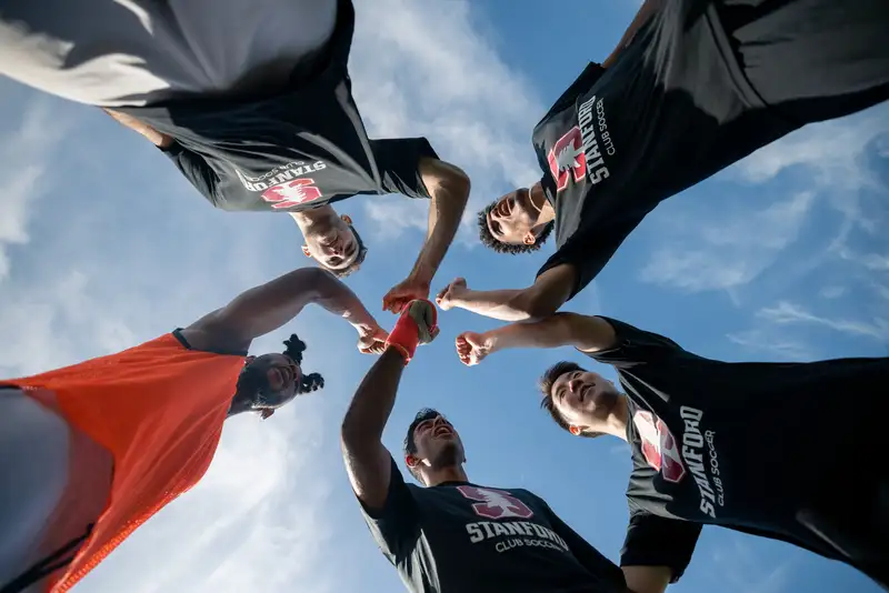 Stanford Club soccer group fist bump