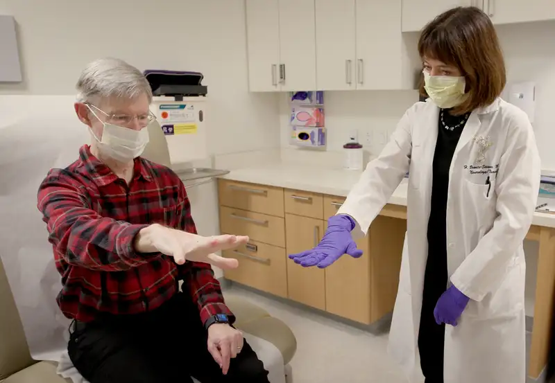 Helen Bronte-Stewart, MD, works with Parkinson's patient Keith Krehbiel. Bronte-Stewart conducted research that led to the development of a deep brain stimulation technology that was recently approved by the U.S. Food and Drug Administration.