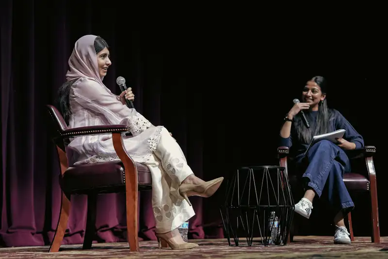 Women having conversation on stage