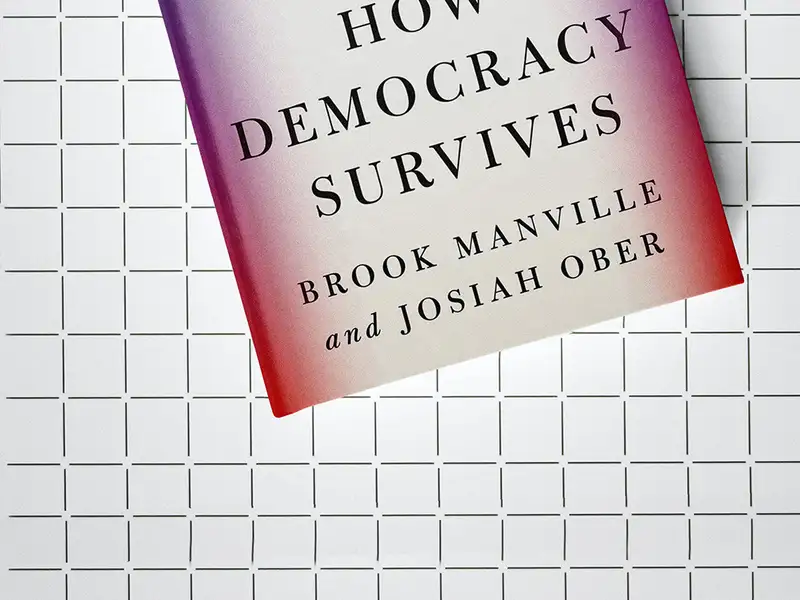 The cover of "The Civic Bargain: How Democracy Survives" by Brook Manville and Josiah Ober, laid flat on a grid-patterned surface.