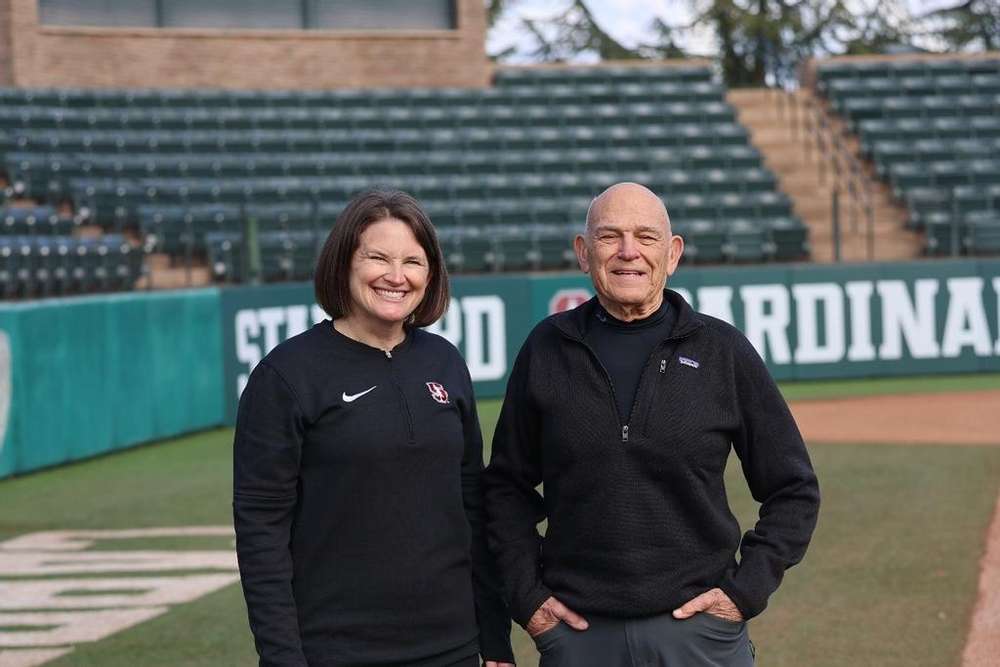 Jessica Allister and Paul Violich, '57 stand together on the Stanford softball field.