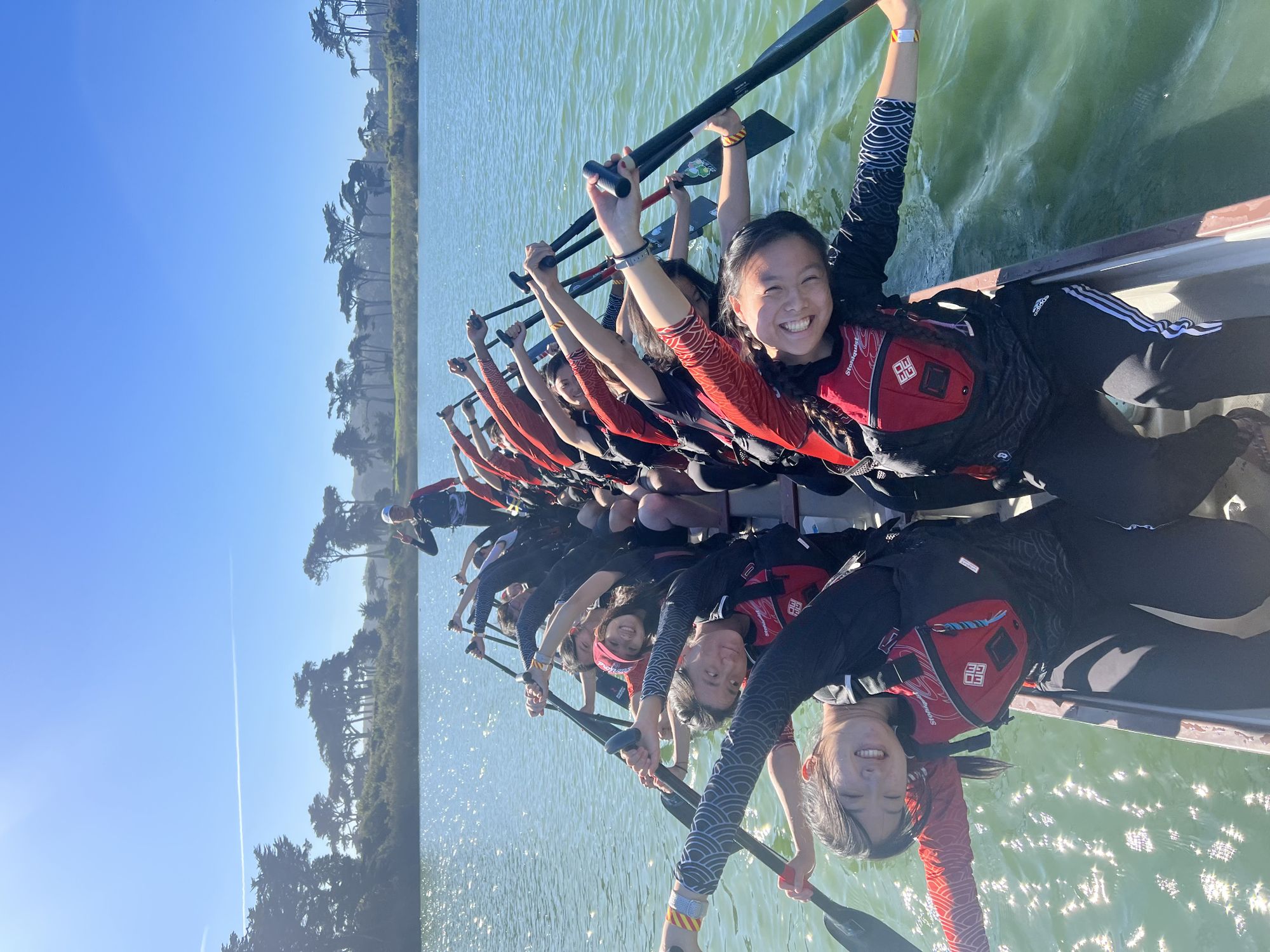 Boaters pose and smile on the dragon boat