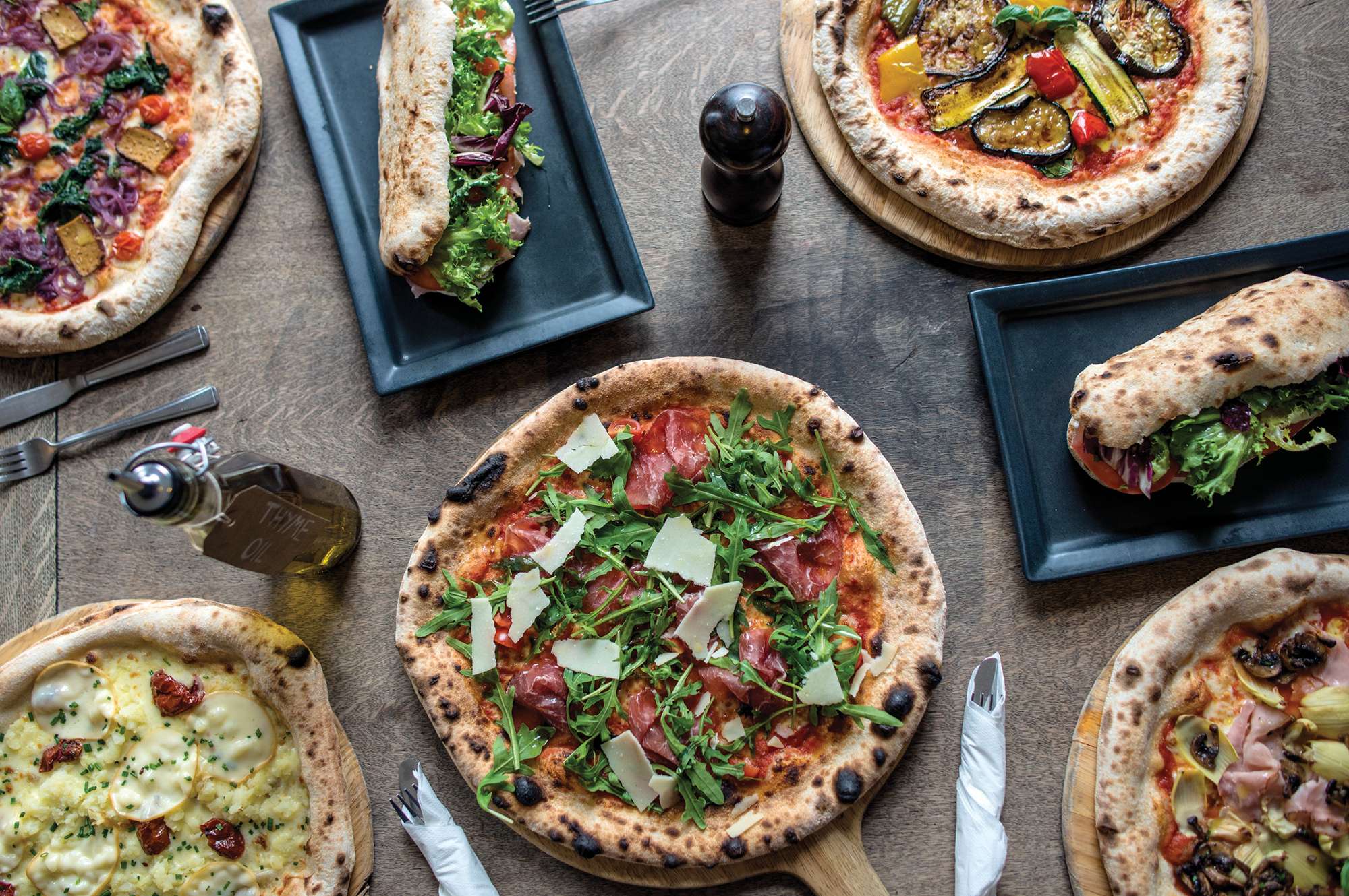 table of rustic pizzas and breads