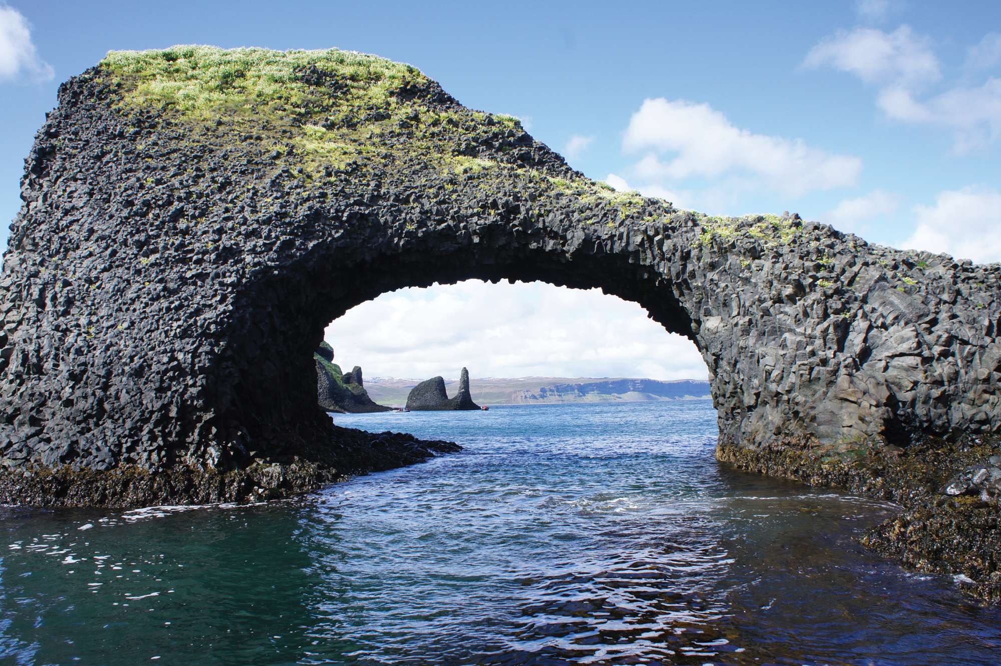 island rock with arch over sea