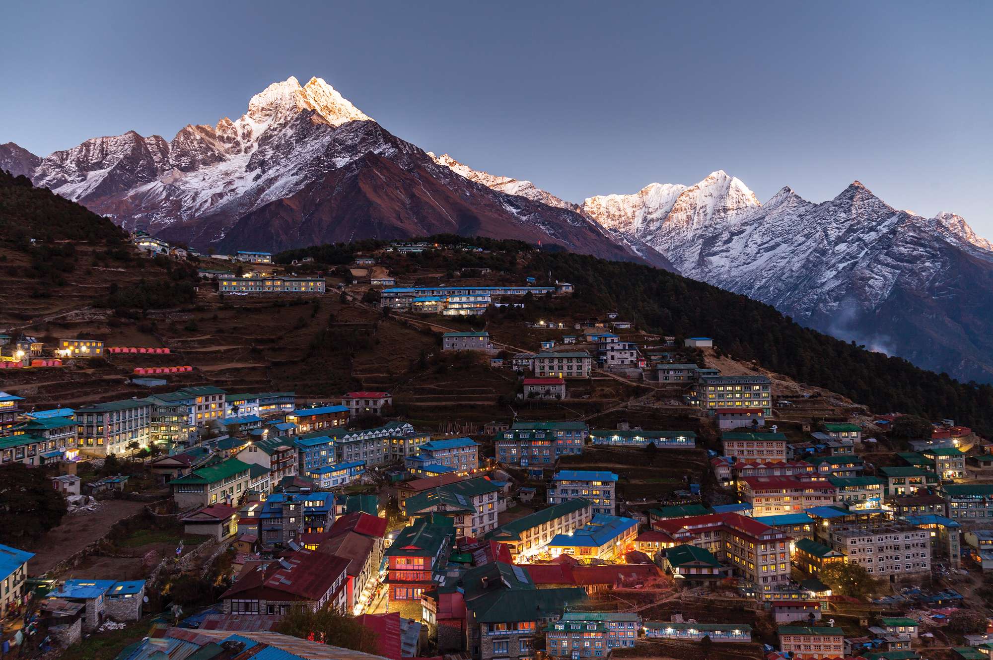 stunning sunset view of village against snow capped mountain range