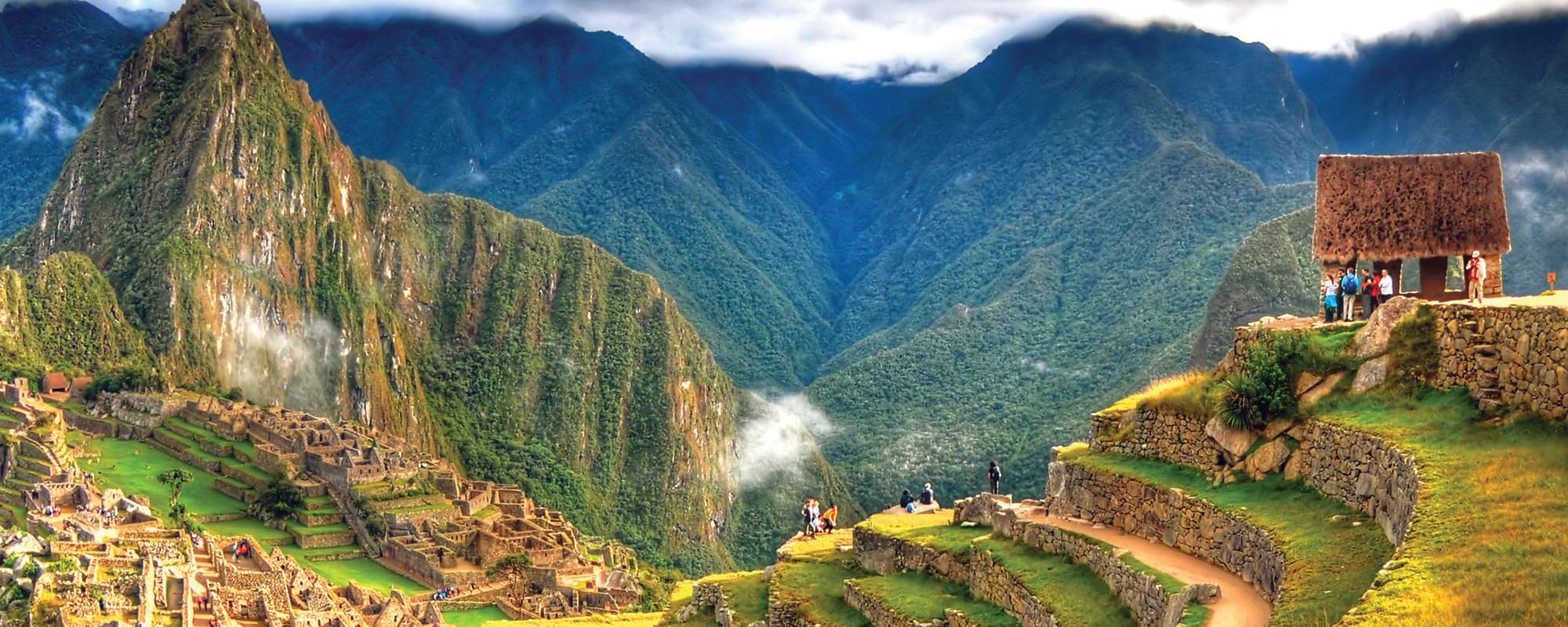 stunning view of machu picchu terraced land with dramatic clouds