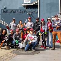 A group of alums standing in front of the San Francisco Sail Boat House Club