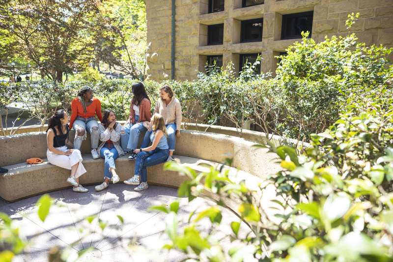 Six female students chat on campus