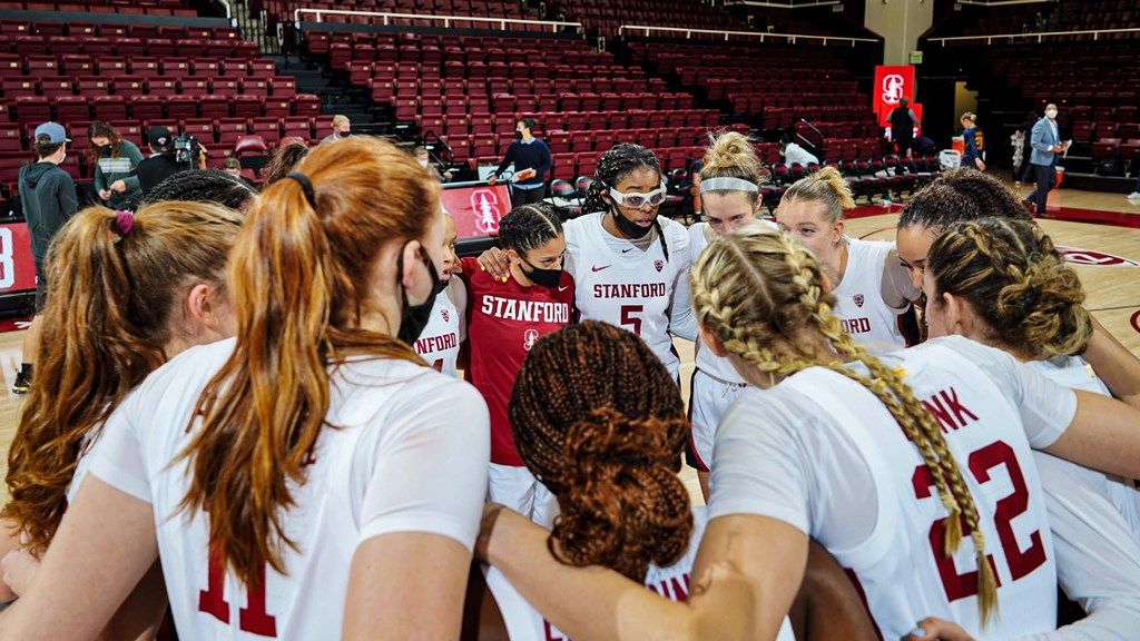 Stanford women basketball players huddle on the court
