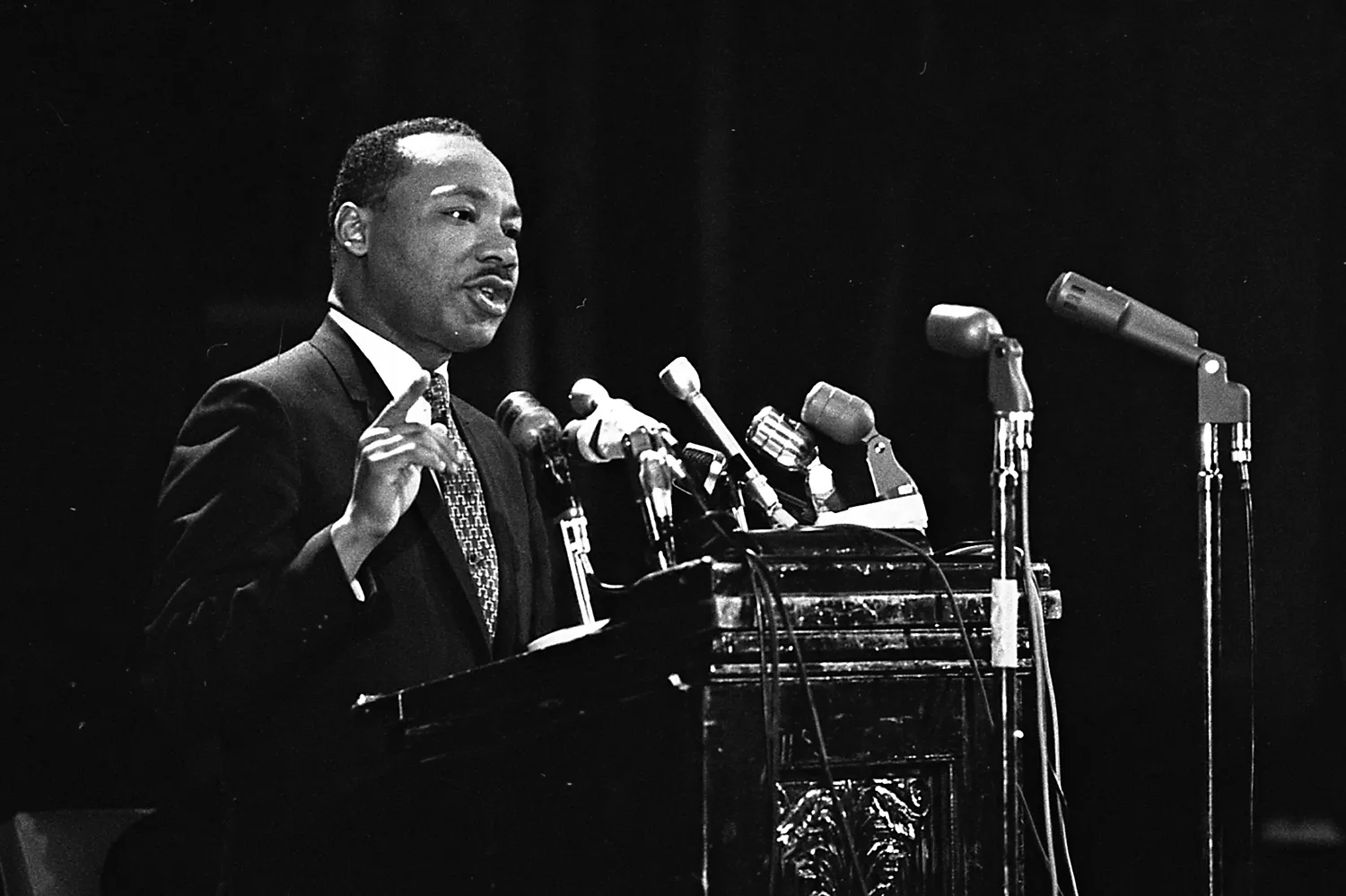 MLK speaks at a podium with microphones
