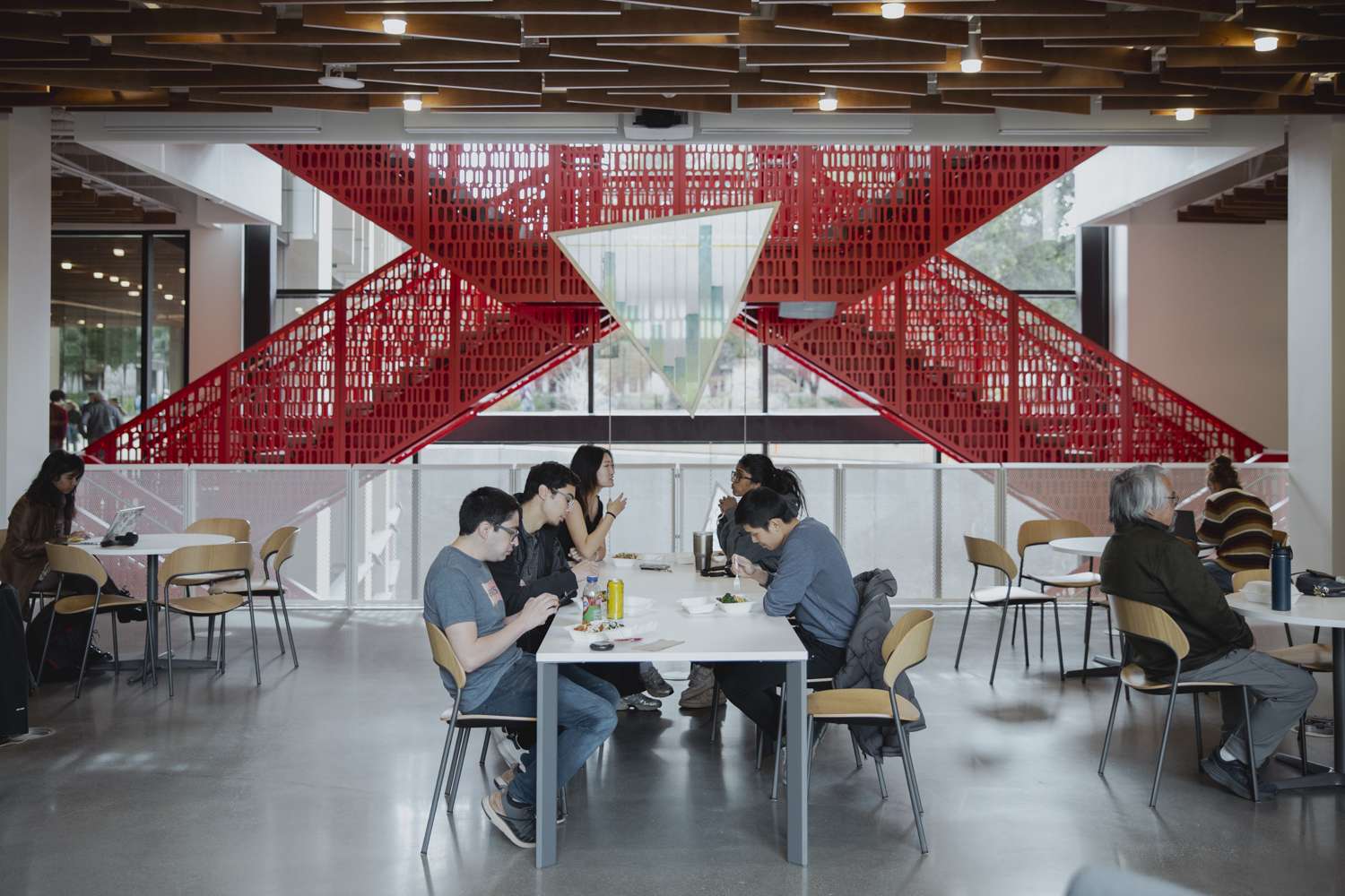 People work at tables in CoDa building