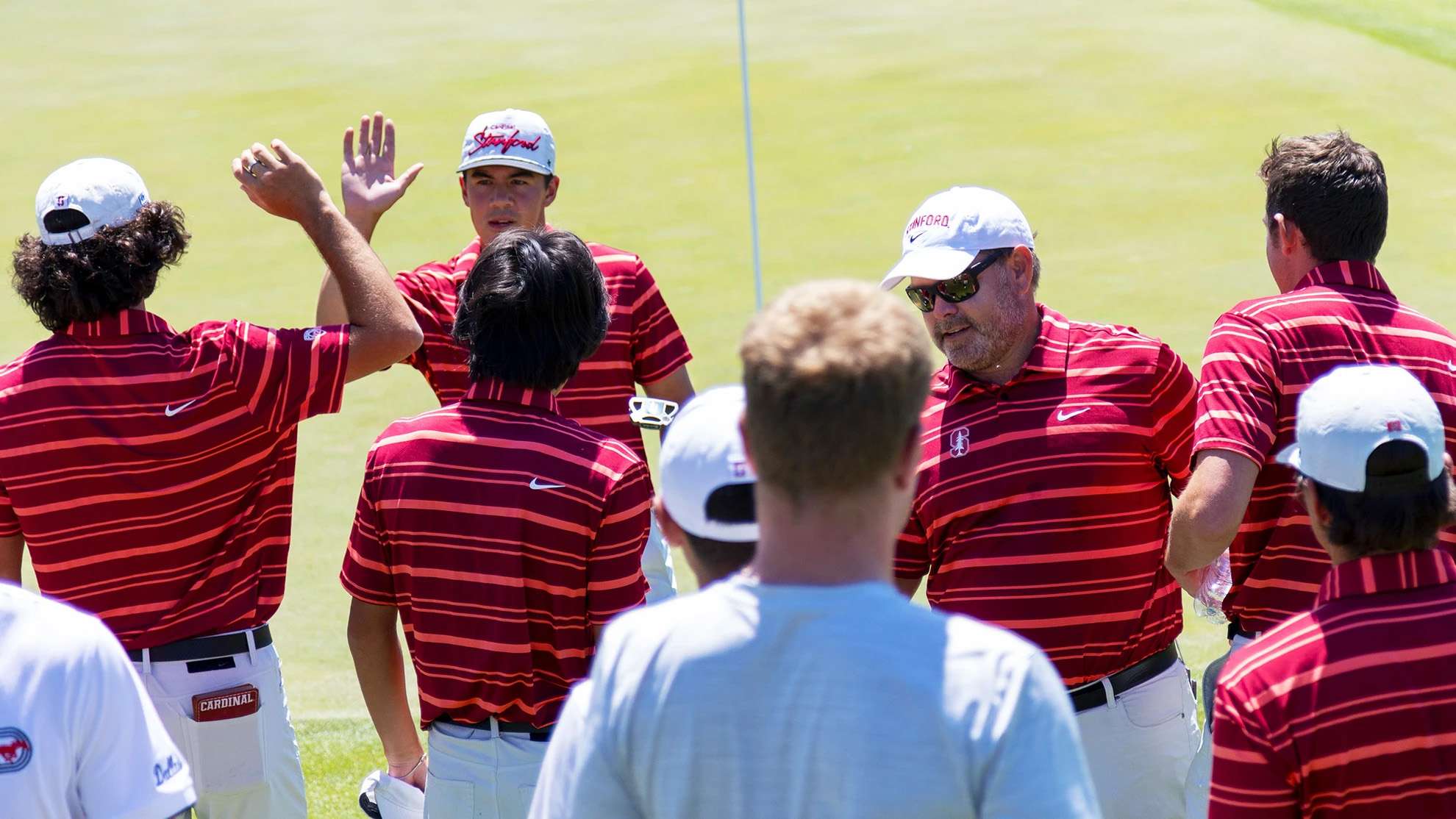 Members of the golf team high five