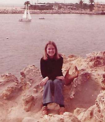 Marie Shipman on rocks near water